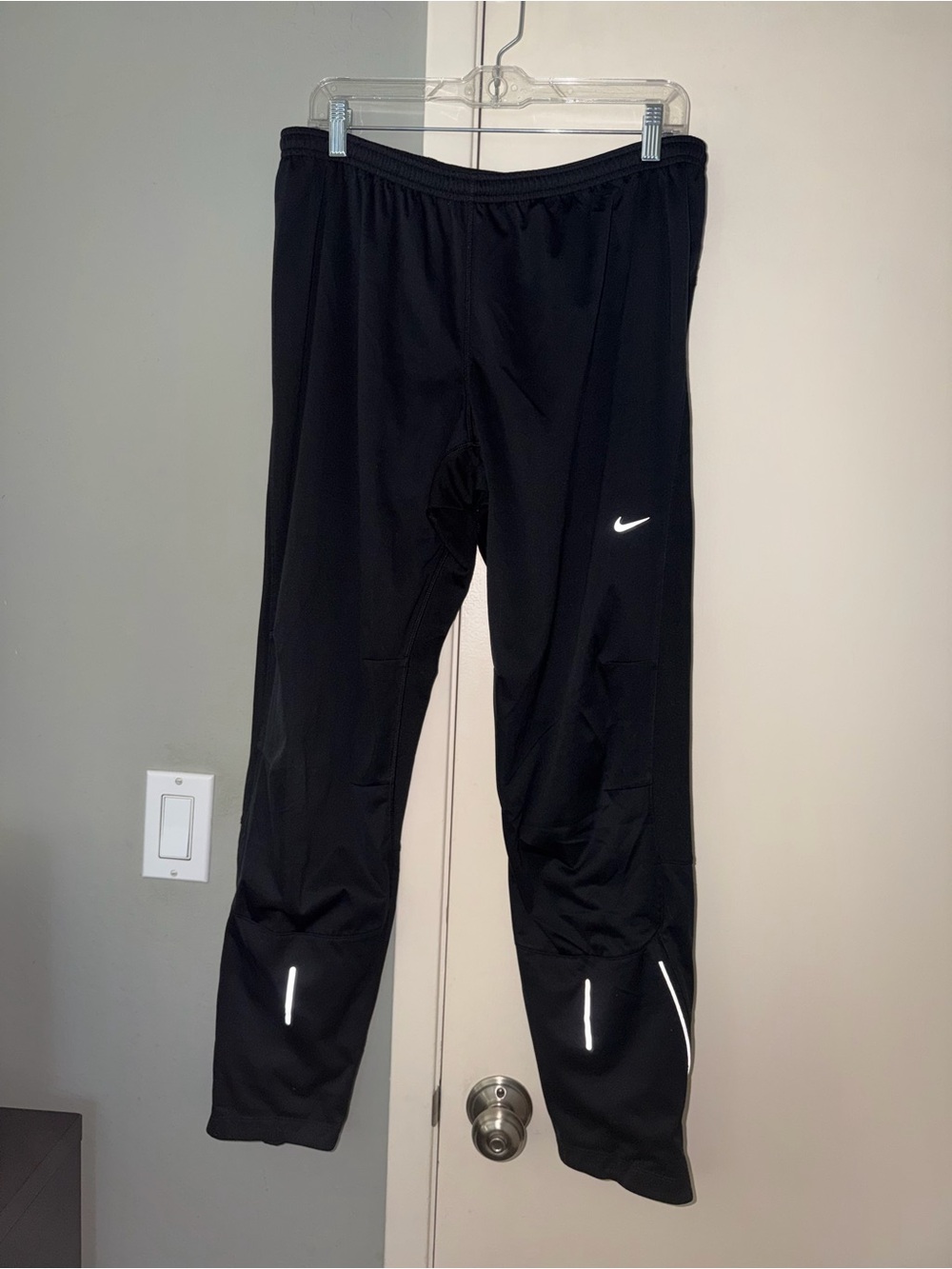 Nike Black Track Pants with White Swoosh and Reflective Details